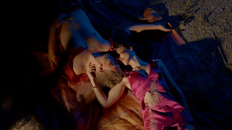 loving couple, lying on the ground, with eyes closed, wearing torn dresses
