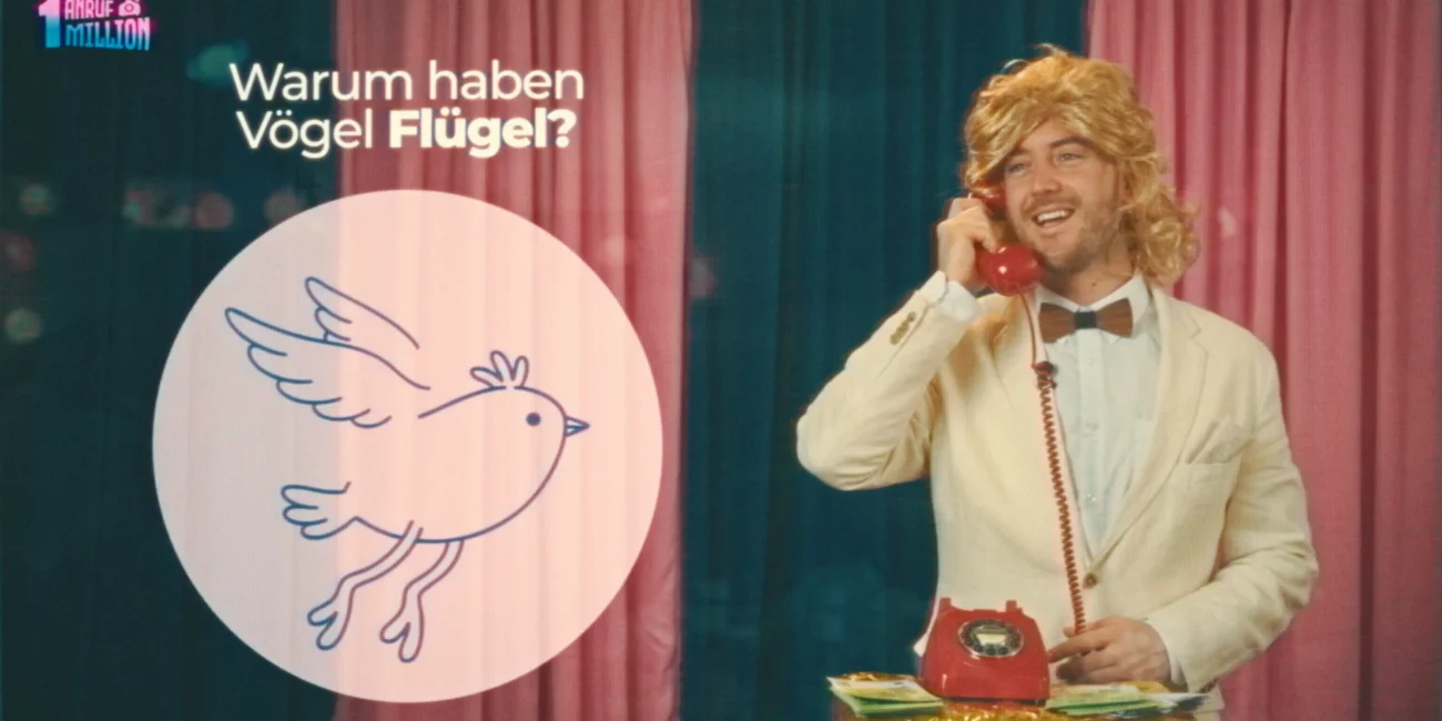 A cinematic still from the Austrian Kiwi comedy sketch 'One Call One Million' produced by Holy Moly Films, showing the host in a retro vintage studio setting.