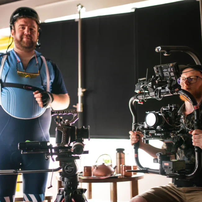 High-production-value camera work by Holy Moly Films, featuring a camera operator with a professional gimbal stabilization system and actor on location.