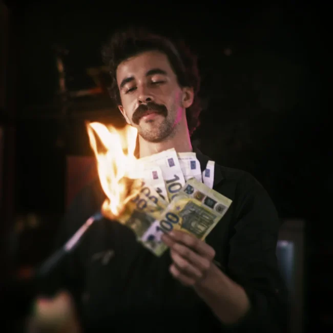 A high-end cinematic still from the Holy Moly Films production, showing an actor burning money with a blowtorch, showcasing compelling visual storytelling.