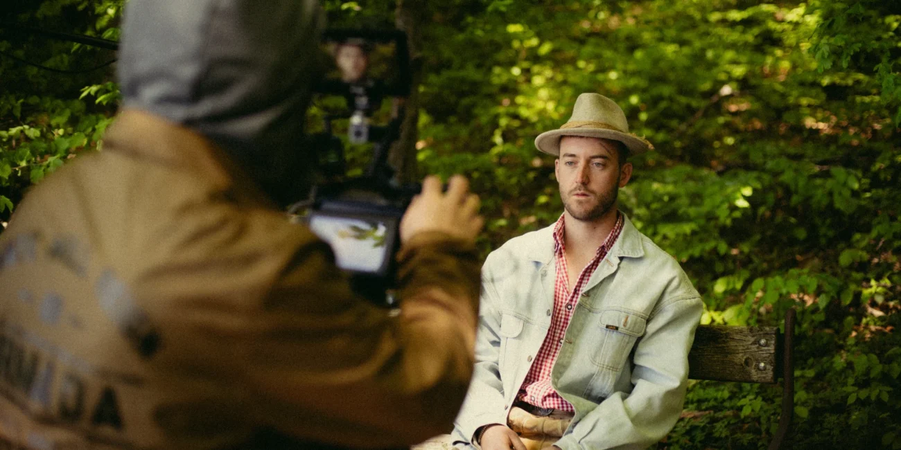 Behind-the-scenes shot of a professional camera operator filming creator Austrian Kiwi, highlighting on-set commercial video production services in Salzburg, Austria.