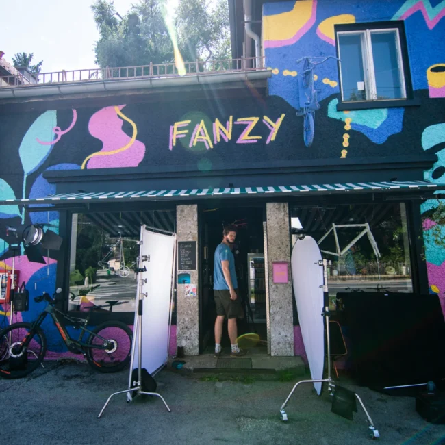 Exterior view of the colorful Fanzy Bikes bicycle shop, featuring Holy Moly Films professional lighting setup.