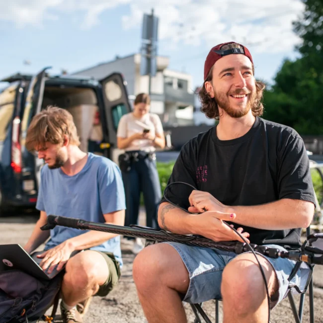 A Holy Moly films team member preparing the boom pole for professional audio recordings on set.