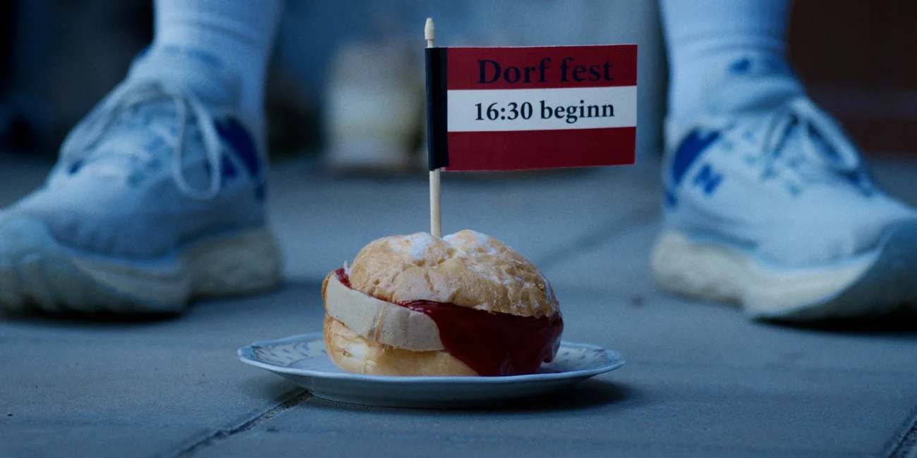 A sharp, cinematic close-up shot of a traditional Austrian Leberkäsesemmel, demonstrating visual comedy for an Austrian Kiwi film production by Holy Moly films.