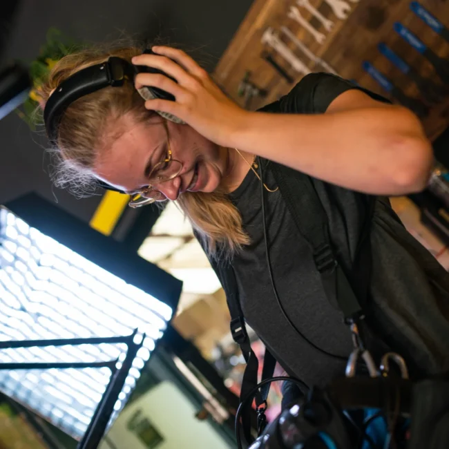 Behind-the-scenes shot of a female Holy Moly Films audio tech with professional recording gear during a Salzburg shoot.