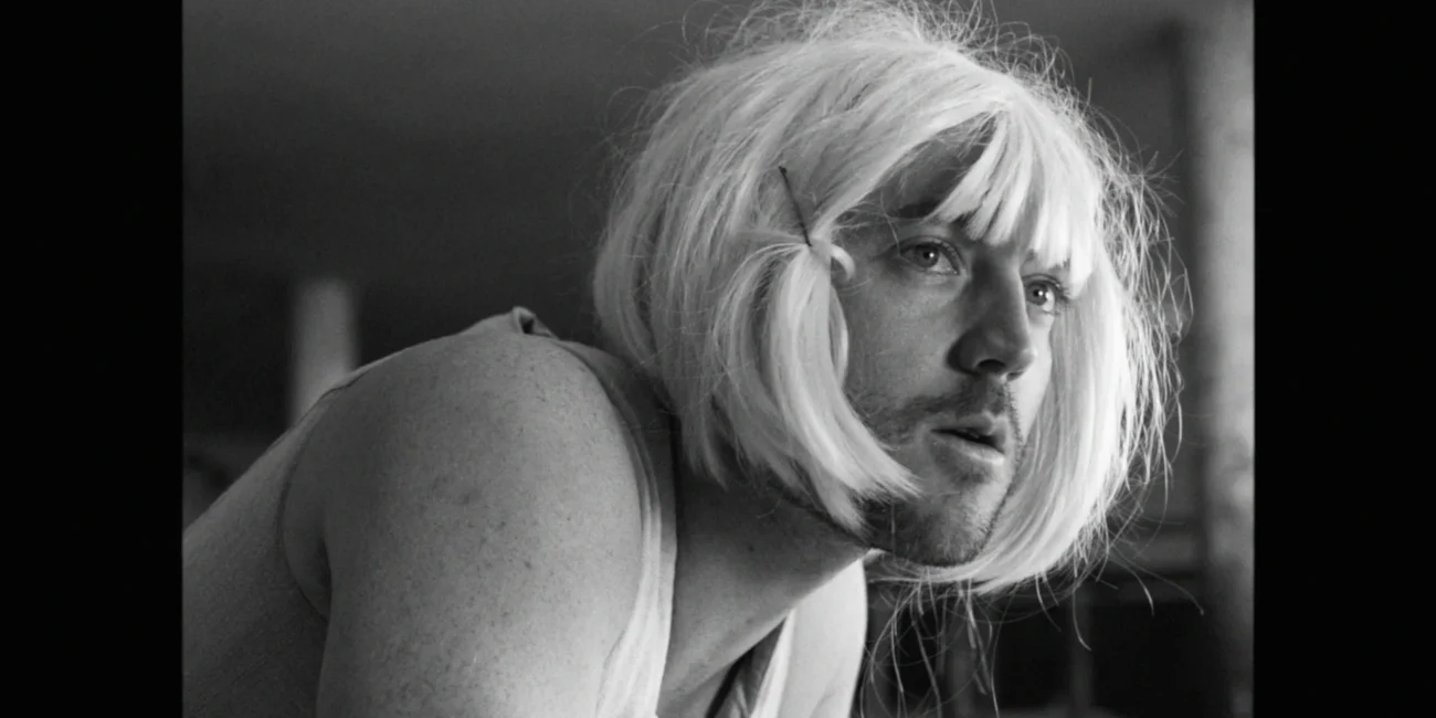 Close-up cinematic portrait of Austrian Kiwi wearing a blonde wig in a video production by Holy Moly Films.