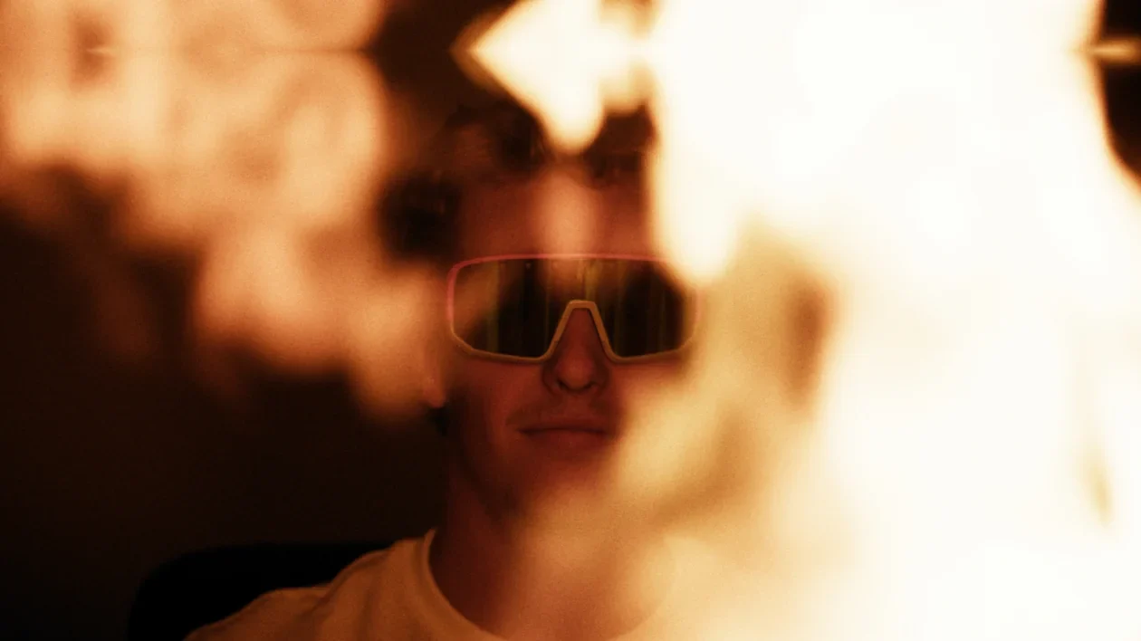 Portrait of a craftsman wearing the Perwein x Naked Optics glasses surrounded by fire.